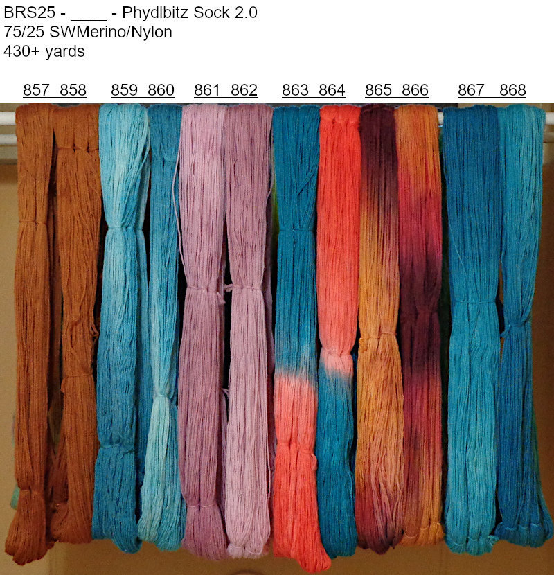 Photo of hand-dyed yarns drying on the rack