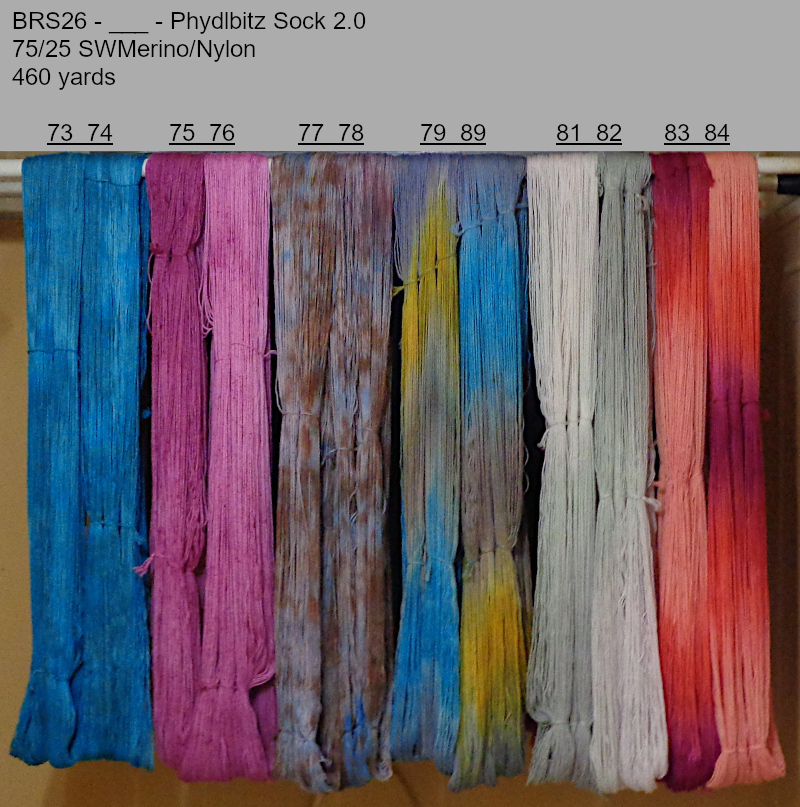 Photo of hand-dyed yarns drying on a rack