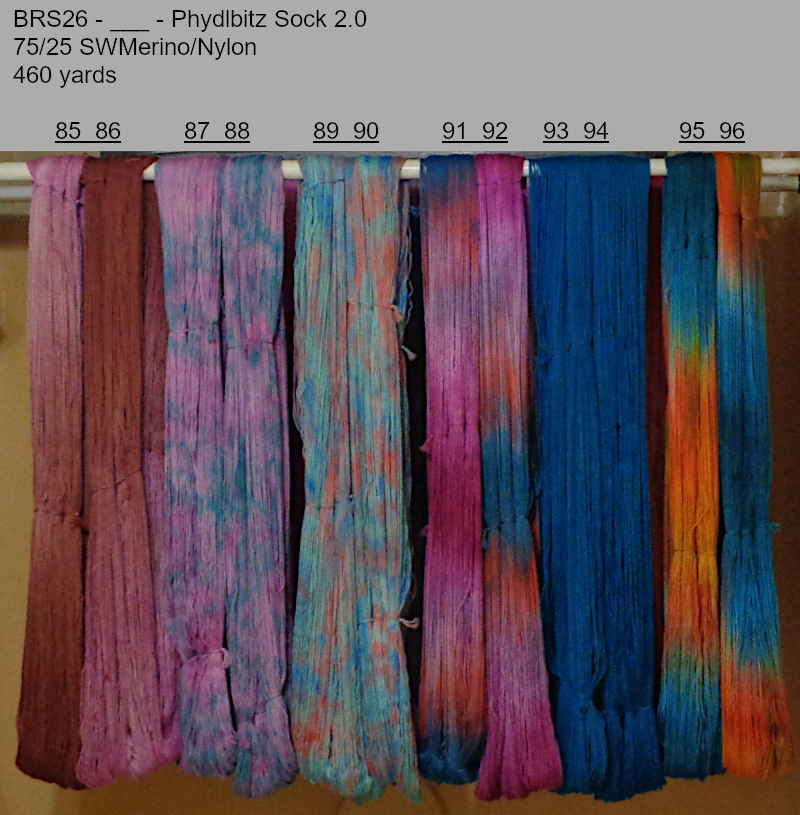 Photo of hand-dyed yarns drying on a rack