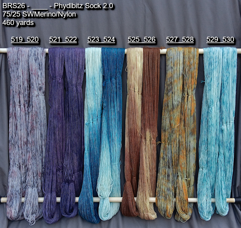 Picture of hand-dyed yarns drying on the rack