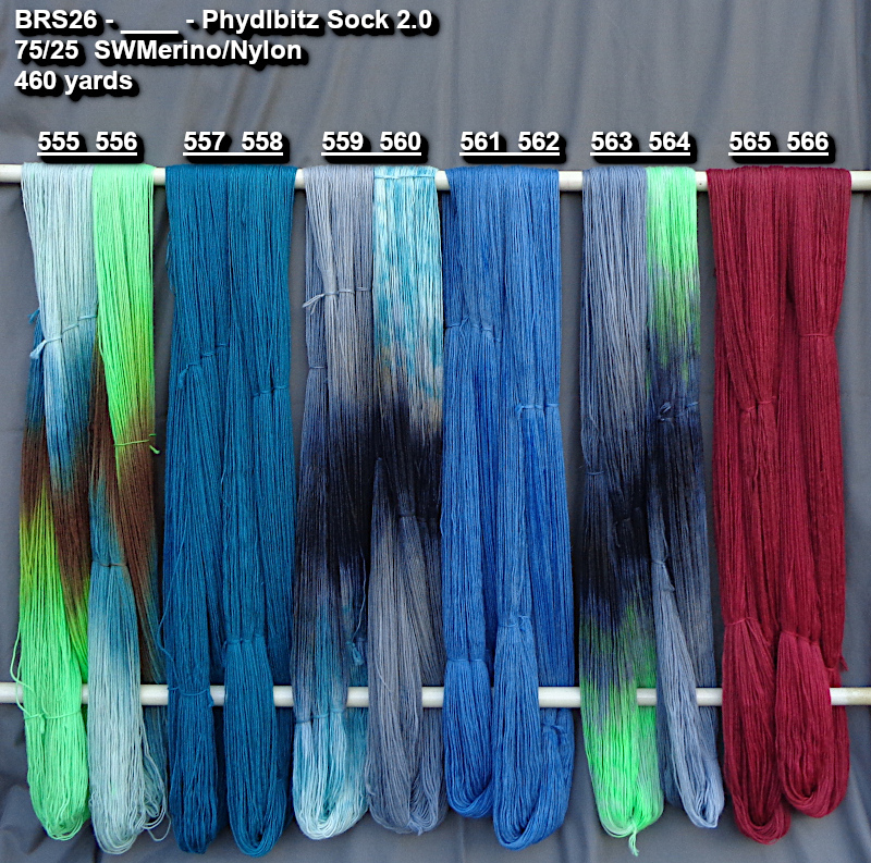 Photo of hand-dyed yarns drying on a rack.