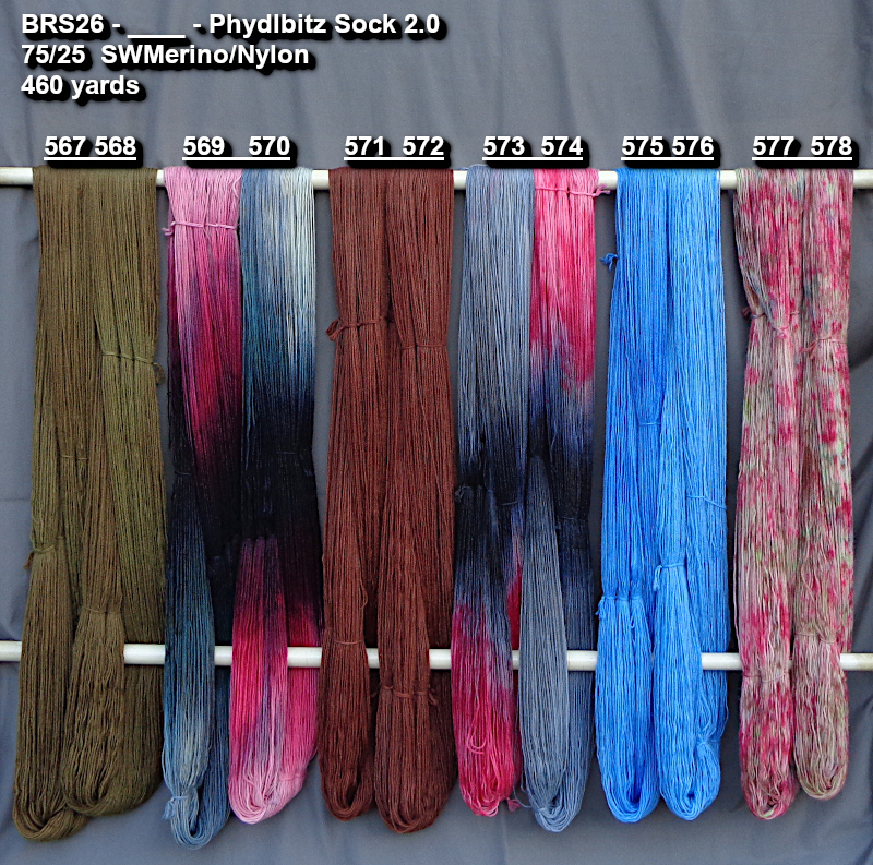 Photo of hand-dyed yarns drying on a rack.