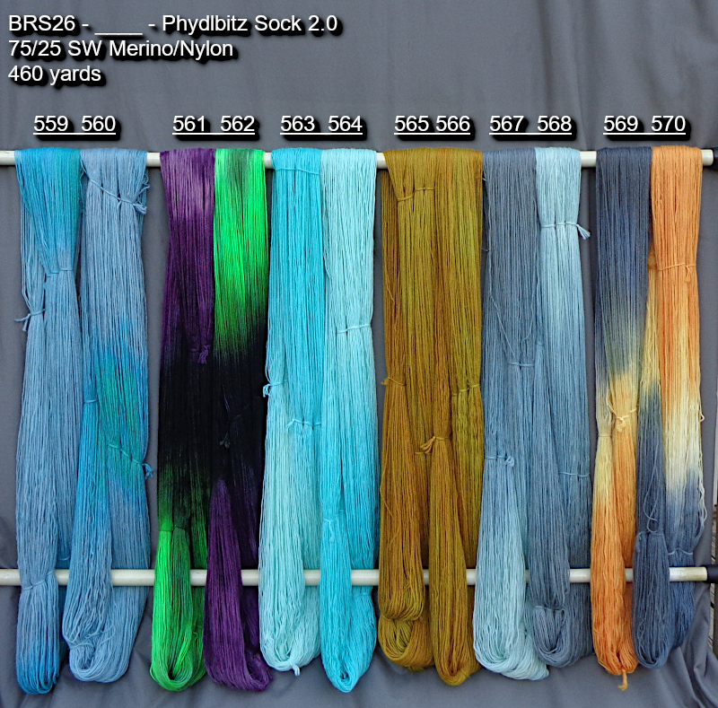 Picture of hand-dyed yarns in many colors, drying on a rack outdoors.