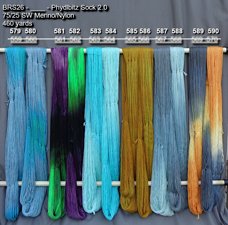 Picture of hand-dyed yarns in many colors, drying on a rack outdoors.