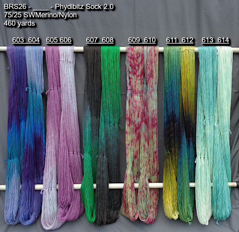 Photo of hand-dyed yarns in many colors drying on a rack.