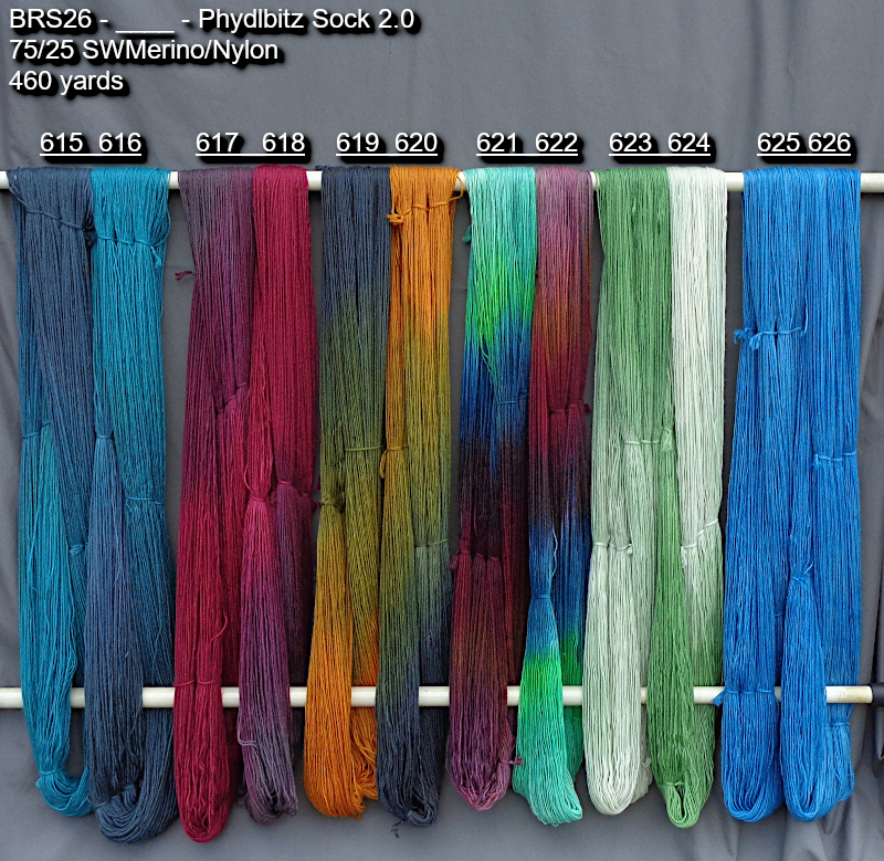 Photo of hand-dyed yarns in many colors drying on a rack.