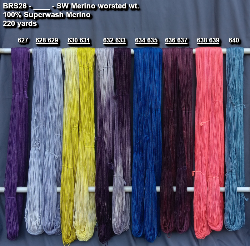 Picture of hand-dyes yarns in many colors, drying on a rack.