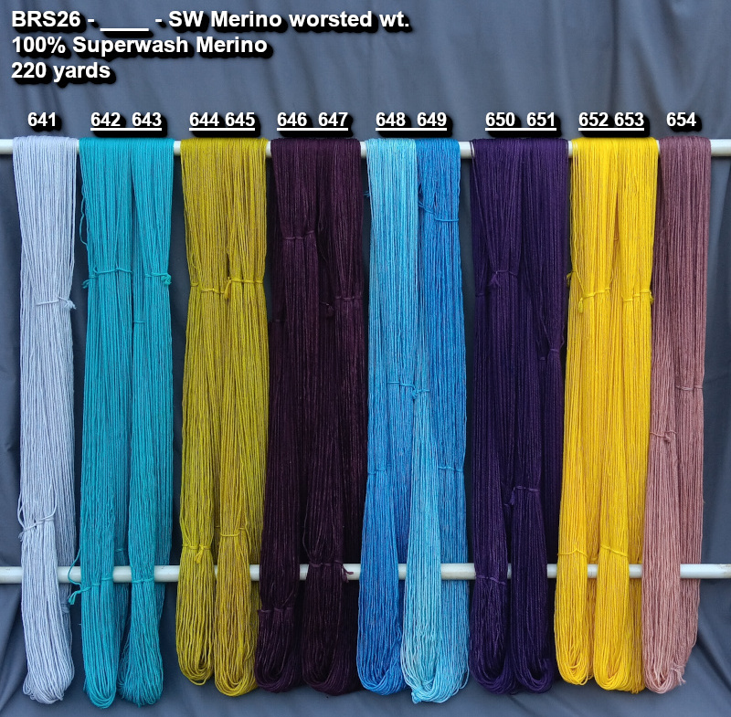 Picture of hand-dyes yarns in many colors, drying on a rack.
