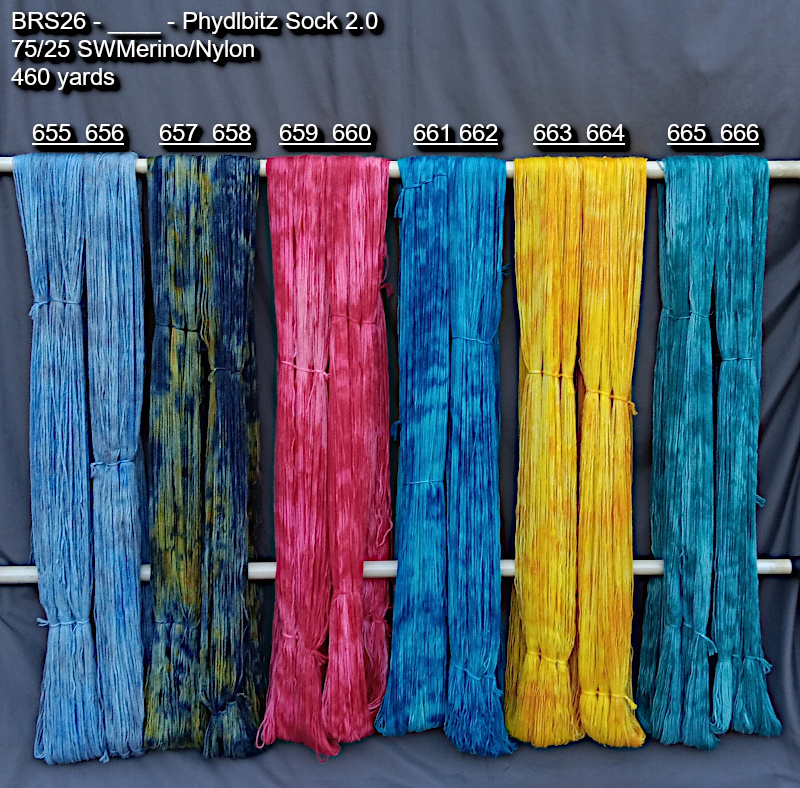 Picture of hand-dyes yarns in many colors, drying on a rack.