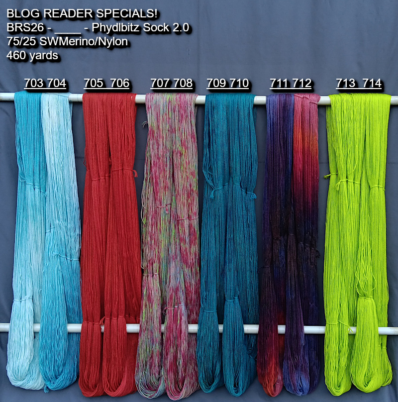 Picture of hand-dyed yarns in many colors, hanging on rack to dry.