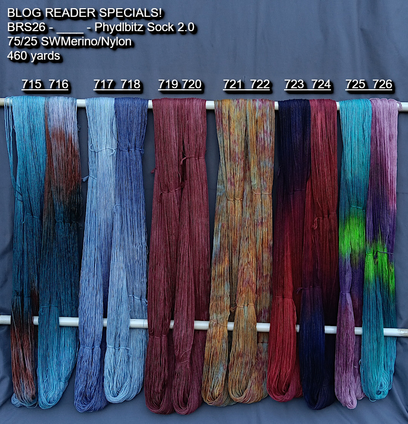 Picture of hand-dyed yarns in many colors, hanging on rack to dry.