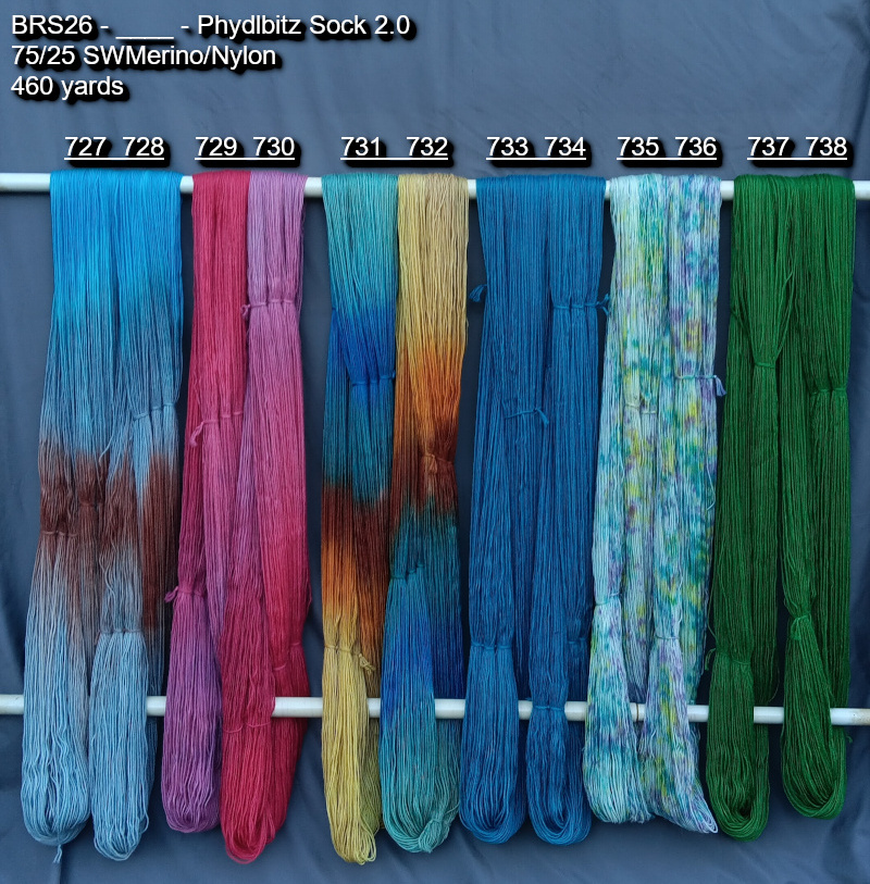 Picture of hand-dyed yarns in many colors, hanging on rack to dry.