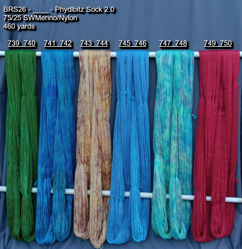 Picture of hand-dyed yarns in many colors, hanging on rack to dry.