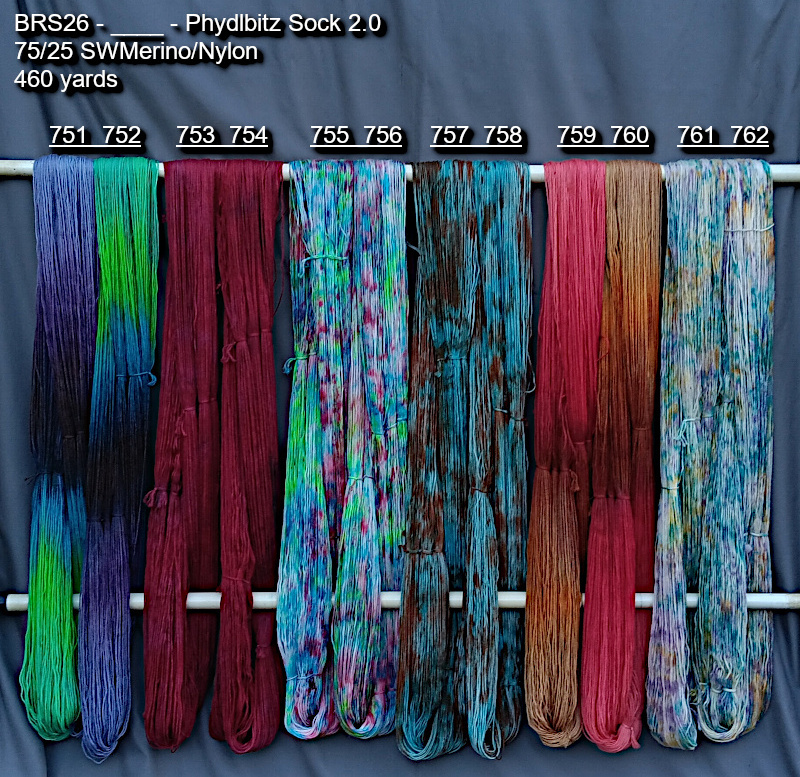 Picture of hand-dyed yarns in many colors, hanging on rack to dry.