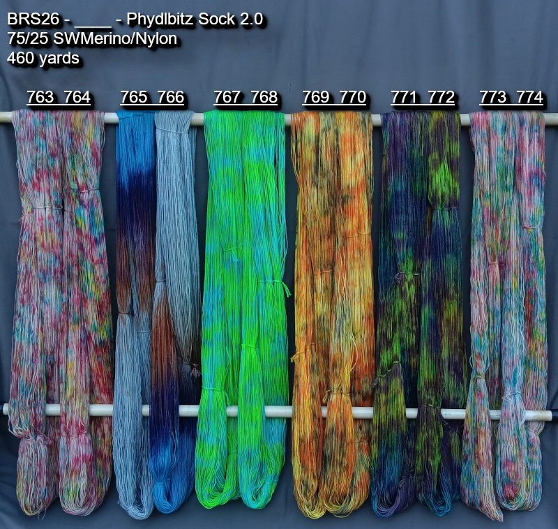 Picture of hand-dyed yarns in many colors, hanging on rack to dry.