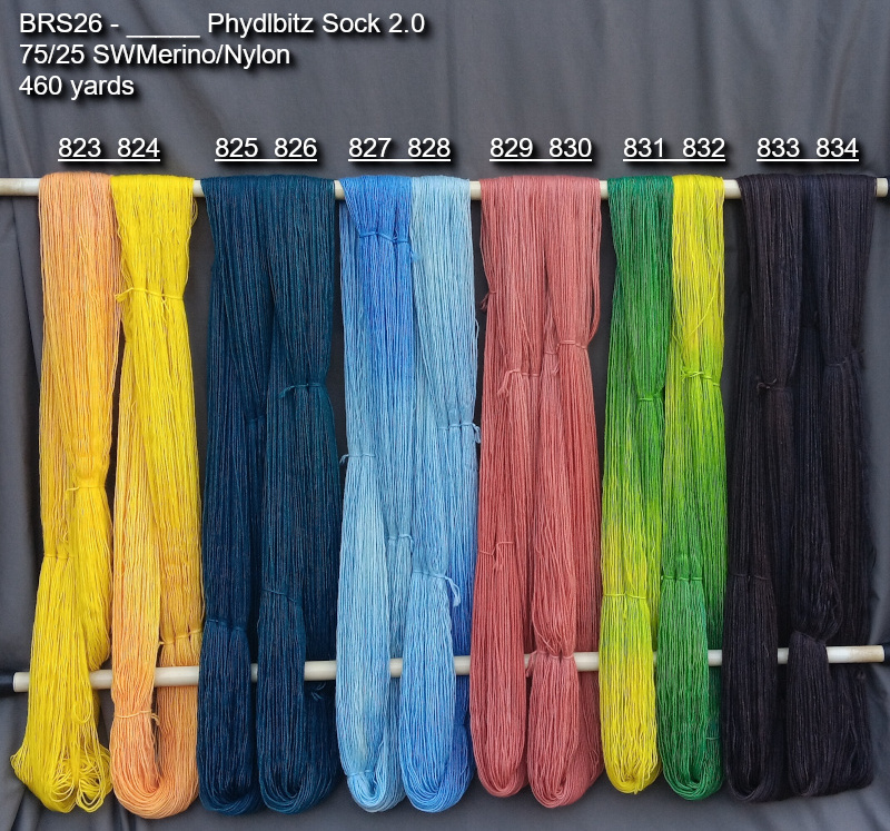 Picture of hand-dyed yarns in many colors, hanging on rack to dry.